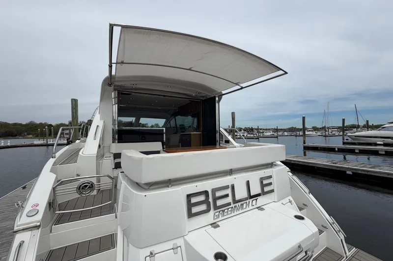 Slide: The Image of 2018 Cruisers Yachts 50 Cantius docked, featuring spacious deck and modern design. - 8