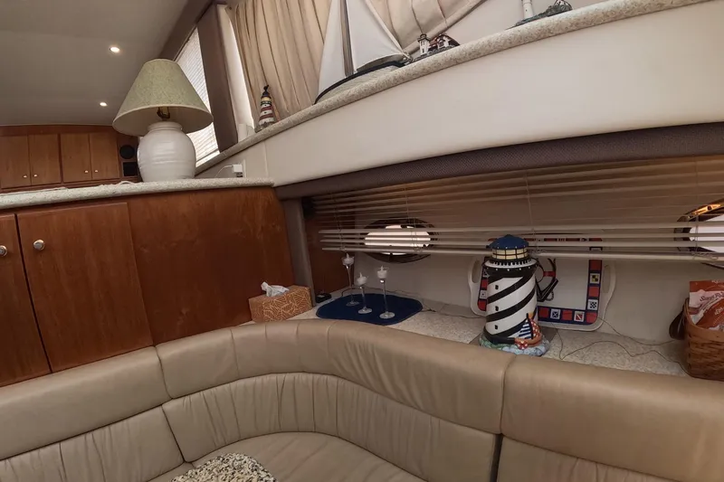 Slide: The Image of Interior of 2000 Carver 406 Motor Yacht with cozy seating and nautical decor. - 14
