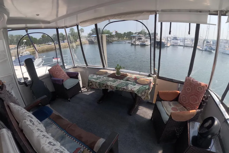 Slide: The Image of Interior of 2000 Carver 406 Motor Yacht with cozy seating and waterfront view. - 17