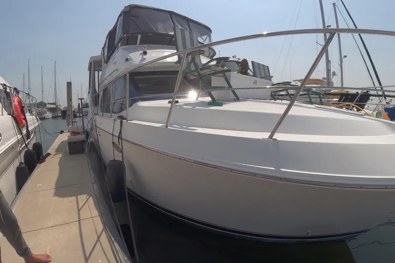Slide: The Image of 2000 Carver 406 Motor Yacht docked at marina, side view. - 21