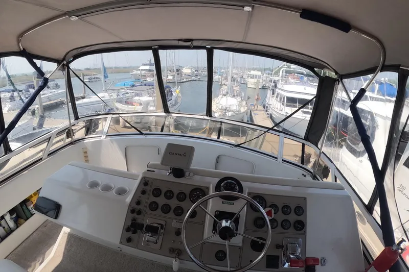 Slide: The Image of Cockpit view of 2000 Carver 406 Motor Yacht docked at marina. - 24