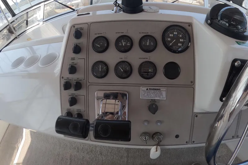 Slide: The Image of Control panel of a 2000 Carver 406 Motor Yacht with gauges and switches. - 25