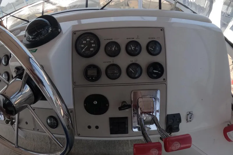 Slide: The Image of Control panel of a 2000 Carver 406 Motor Yacht with steering wheel and gauges. - 26