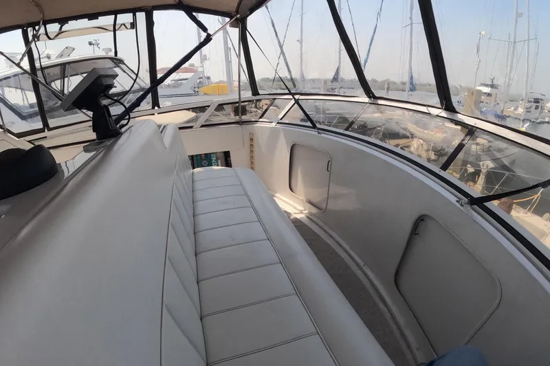 Slide: The Image of 2000 Carver 406 Motor Yacht interior with seating and marina view. - 28