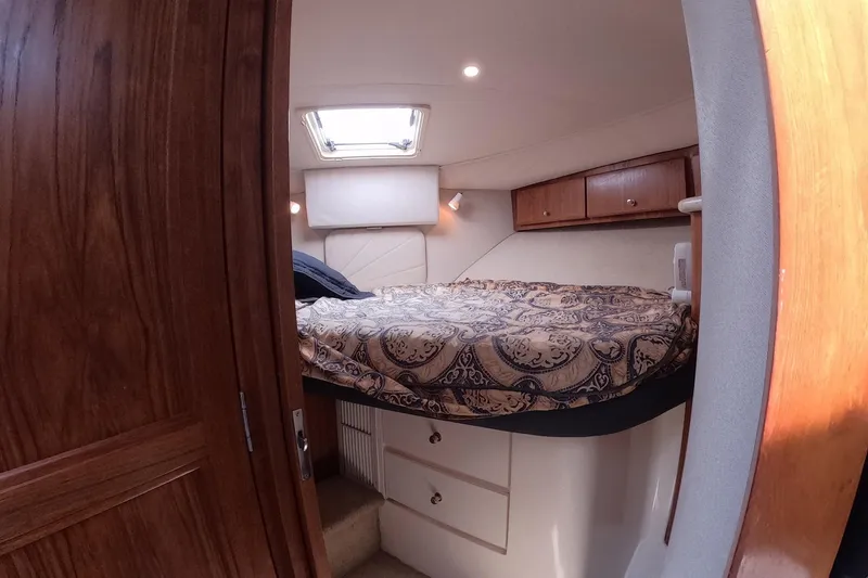 Slide: The Image of Interior cabin of 2000 Carver 406 Motor Yacht with bed and wooden cabinetry. - 3