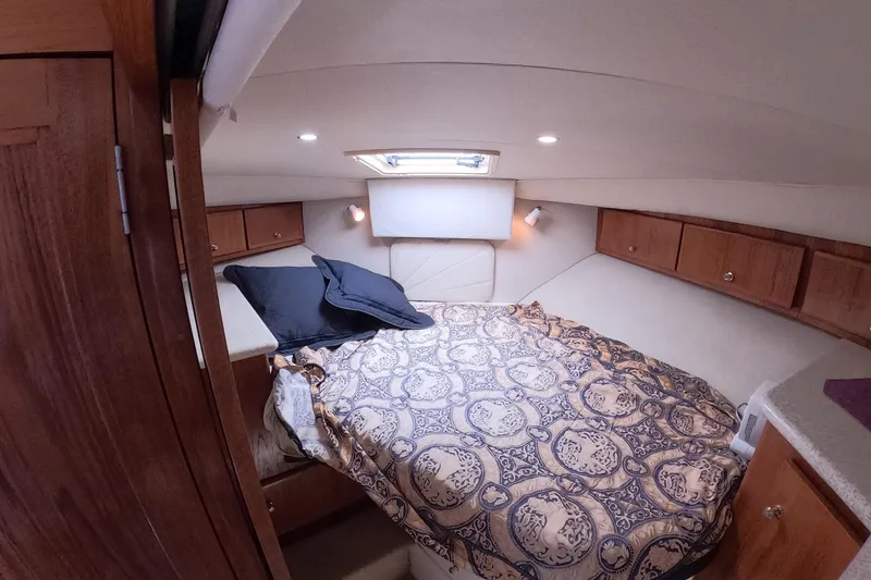 Slide: The Image of Interior cabin of 2000 Carver 406 Motor Yacht with cozy bed and wooden cabinetry. - 5