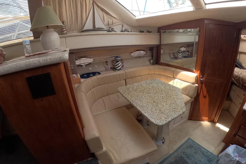 Slide: The Image of Interior of 2000 Carver 406 Motor Yacht with cozy seating and elegant decor. - 6