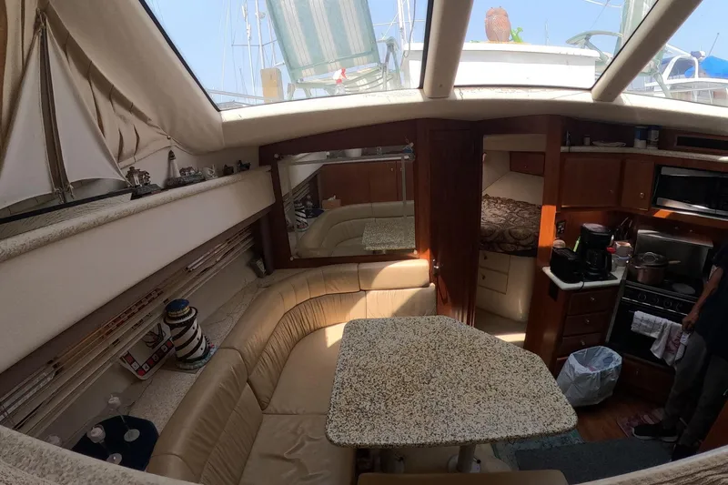 Slide: The Image of Interior of a 2000 Carver 406 Motor Yacht with dining area and kitchenette. - 7