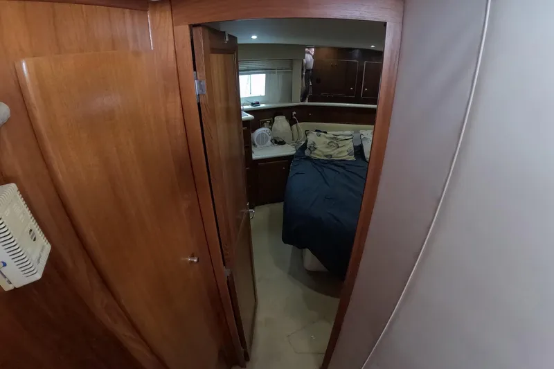 Slide: The Image of Interior cabin of 2000 Carver 406 Motor Yacht with bed and wooden furnishings. - 8