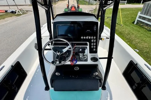Slide: The Image of 2017 Blue Wave 2400 PureBay boat dashboard with steering wheel and control panel. - 10