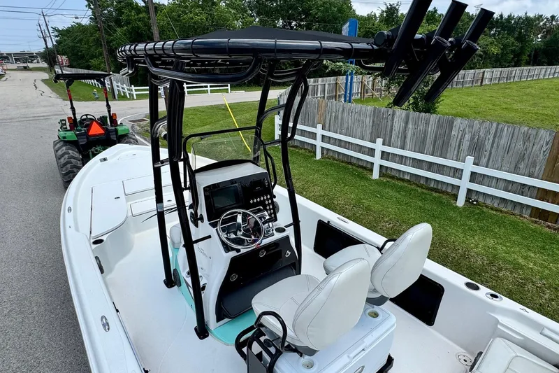 Slide: The Image of 2017 Blue Wave 2400 PureBay boat with dual seats and steering console on a road. - 17