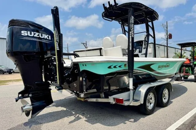 Slide: The Image of 2017 Blue Wave 2400 PureBay boat with Suzuki engine on a trailer. - 4