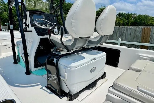 Slide: The Image of 2017 Blue Wave 2400 PureBay boat interior with dual seats and cooler storage. - 8