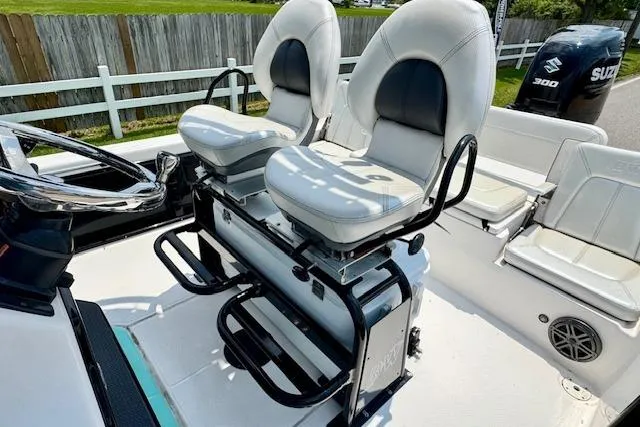 Slide: The Image of 2017 Blue Wave 2400 PureBay boat interior with dual captain's chairs and Suzuki 300 engine. - 9