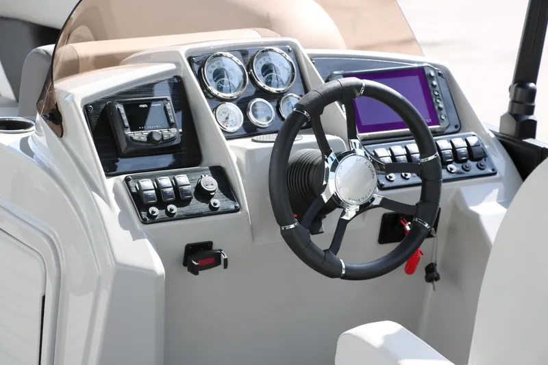 Slide: The Image of 2025 Sylvan Mirage X3 boat dashboard with steering wheel and modern controls. - 18