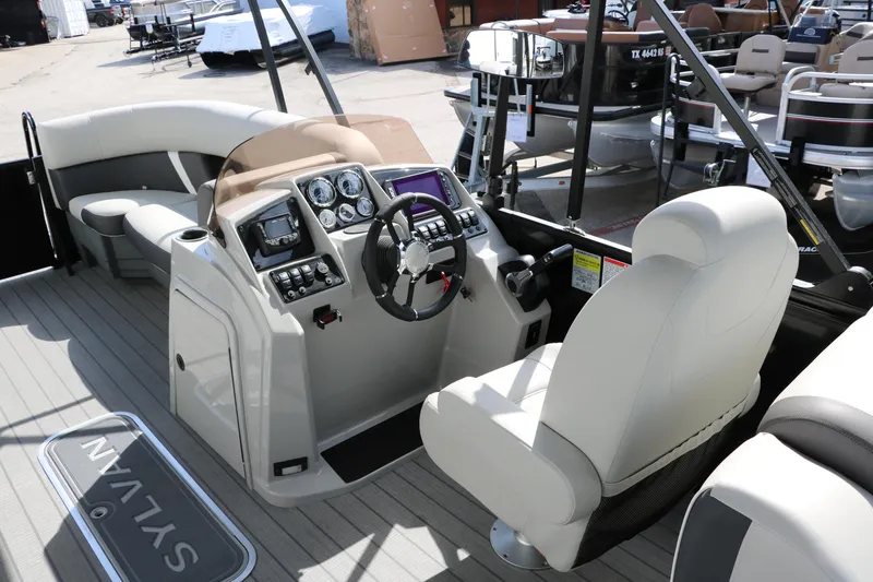 Slide: The Image of 2025 Sylvan Mirage X3 boat interior with modern dashboard and comfortable seating. - 22
