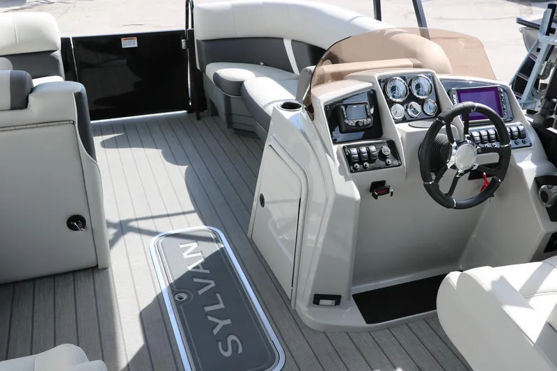 Slide: The Image of 2025 Sylvan Mirage X3 boat interior with modern dashboard and seating. - 23