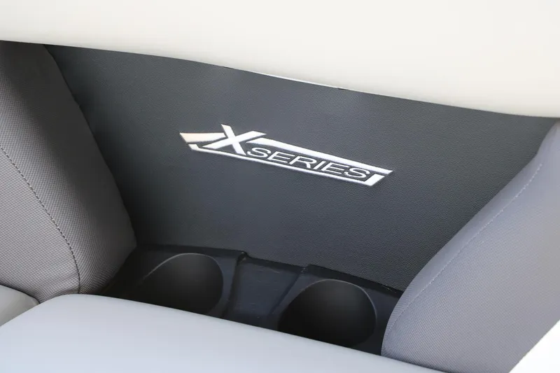 Slide: The Image of 2025 Sylvan Mirage X3 interior with X-Series logo and cup holders. - 27