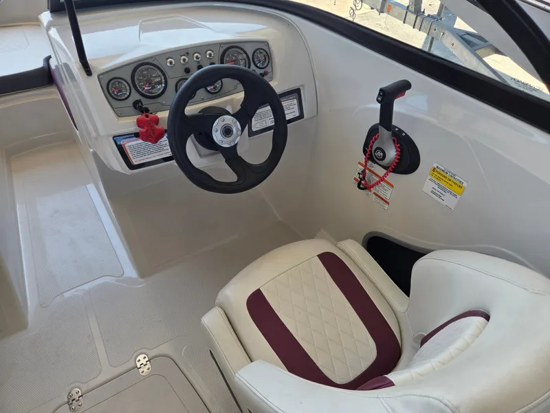 Slide: The Image of Interior of a 2016 Tahoe 450 TS boat with steering wheel and seat. - 10