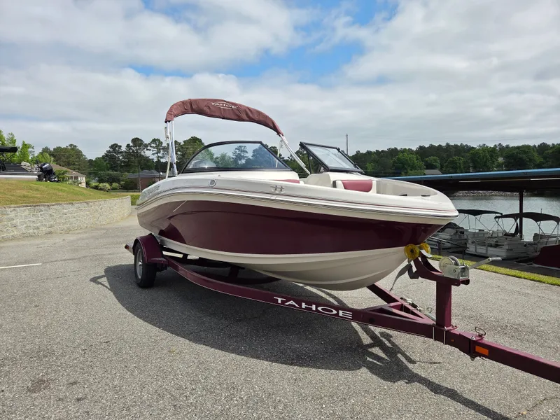 Slide: The Image of 2016 Tahoe 450 TS boat on trailer by lakeside. - 3