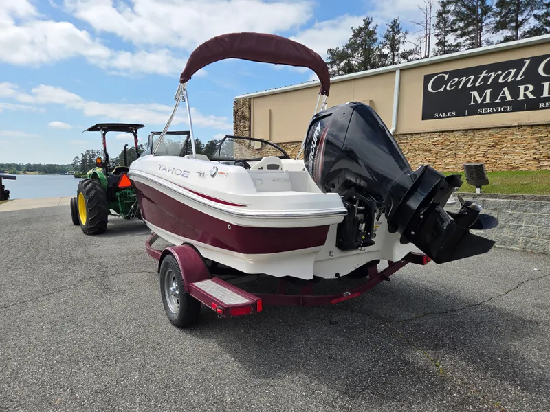 Slide: The Image of 2016 Tahoe 450 TS boat on trailer at marina. - 4