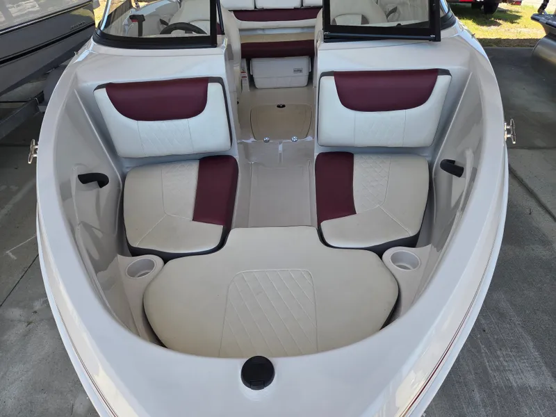 Slide: The Image of Interior of a 2016 Tahoe 450 TS boat with red and white seating. - 7
