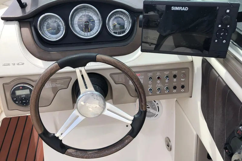 Slide: The Image of Steering console of a 2012 Sea Ray 210 SLX boat with Simrad display and gauges. - 11
