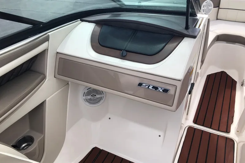 Slide: The Image of Interior of a 2012 Sea Ray 210 SLX boat with sleek design and wood accents. - 12