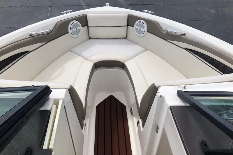 Slide: The Image of Interior view of 2012 Sea Ray 210 SLX boat with cushioned seating and speakers. - 13