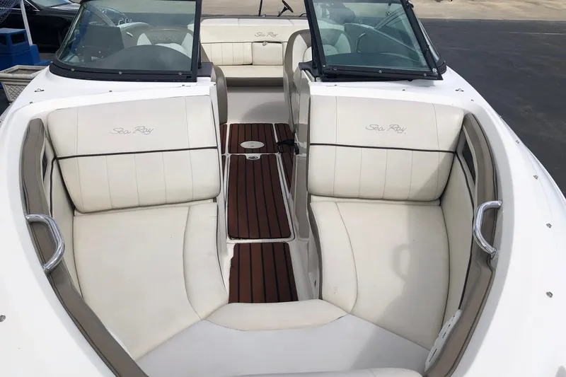Slide: The Image of 2012 Sea Ray 210 SLX boat interior with white seating and wood accents. - 7