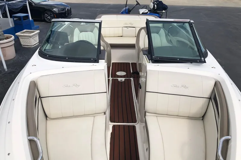 Slide: The Image of 2012 Sea Ray 210 SLX boat with white seating and wooden deck details. - 9