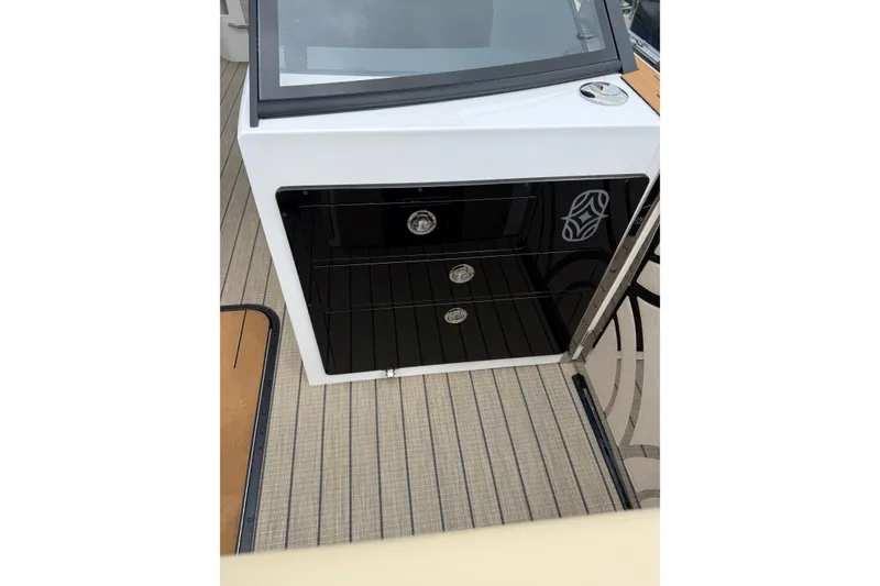 Slide: The Image of Balise Helix 26 L 2025 boat interior with sleek black storage drawers. - 10