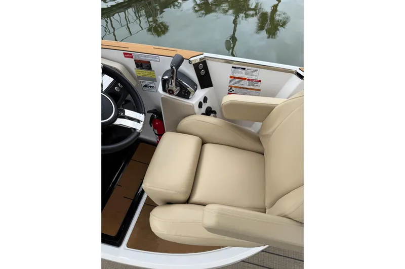 Slide: The Image of Helm seat and controls of 2025 Balise Helix 26 L boat, featuring beige upholstery. - 15