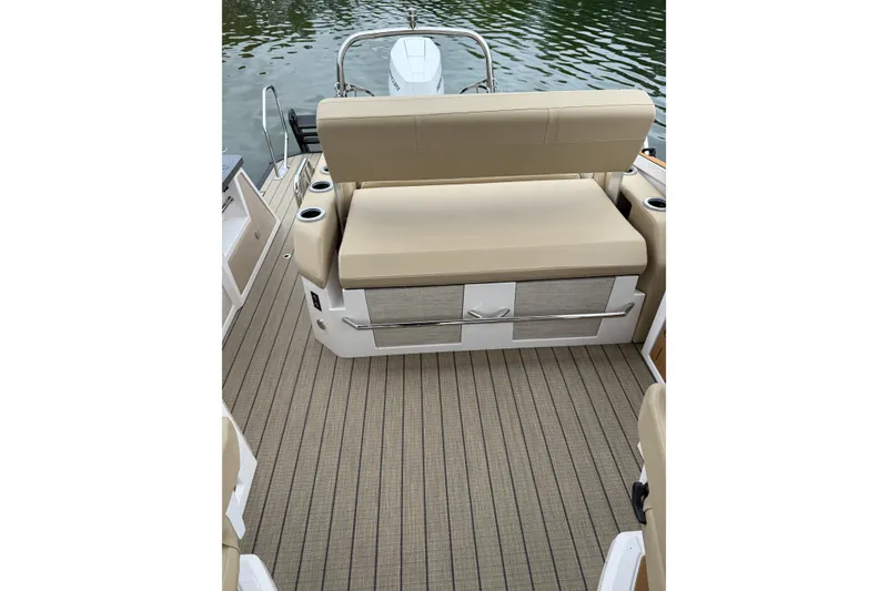 Slide: The Image of 2025 Balise Helix 26 L boat interior with beige seating and striped flooring. - 20