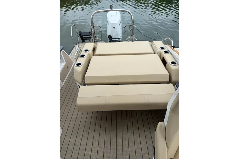 Slide: The Image of Luxury seating on Balise Helix 26 L boat, 2025 model, with cup holders and water view. - 6