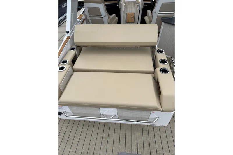 Slide: The Image of 2025 Balise Helix 26 L boat interior with beige seating and cup holders. - 7