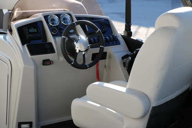Slide: The Image of Interior view of 2025 Sylvan Mirage X1 boat cockpit with steering wheel and controls. - 20