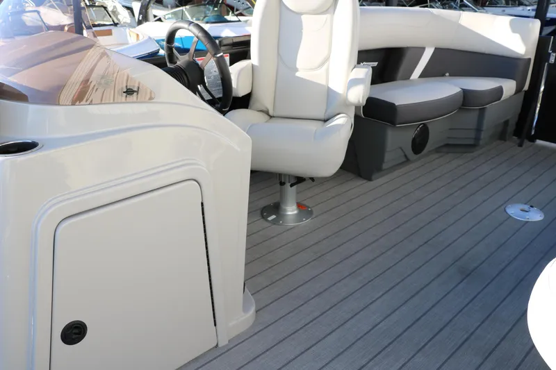 Slide: The Image of 2025 Sylvan Mirage X1 boat interior with seating and steering area. - 25