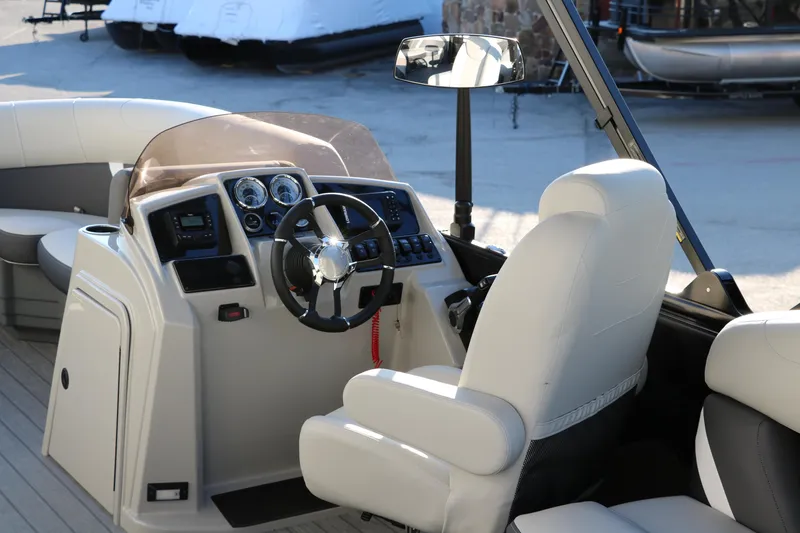 Slide: The Image of 2025 Sylvan Mirage X1 boat interior with steering wheel and dashboard controls. - 18