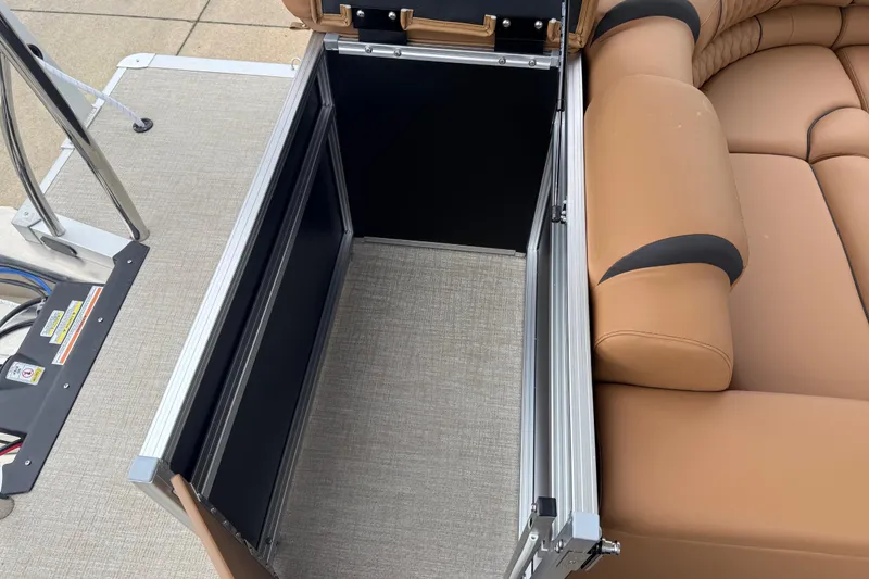 Slide: The Image of Open storage compartment on 2026 Avalon Catalina Cruise Funship, featuring tan seating and metal frame. - 28