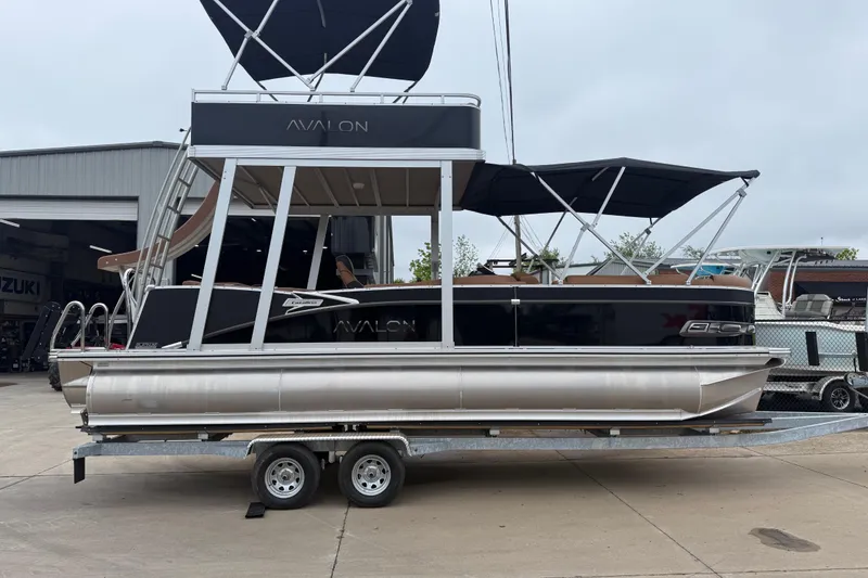 Slide: The Image of 2026 Avalon Catalina Cruise Funship 25' pontoon boat on trailer, featuring sleek design and canopy. - 3