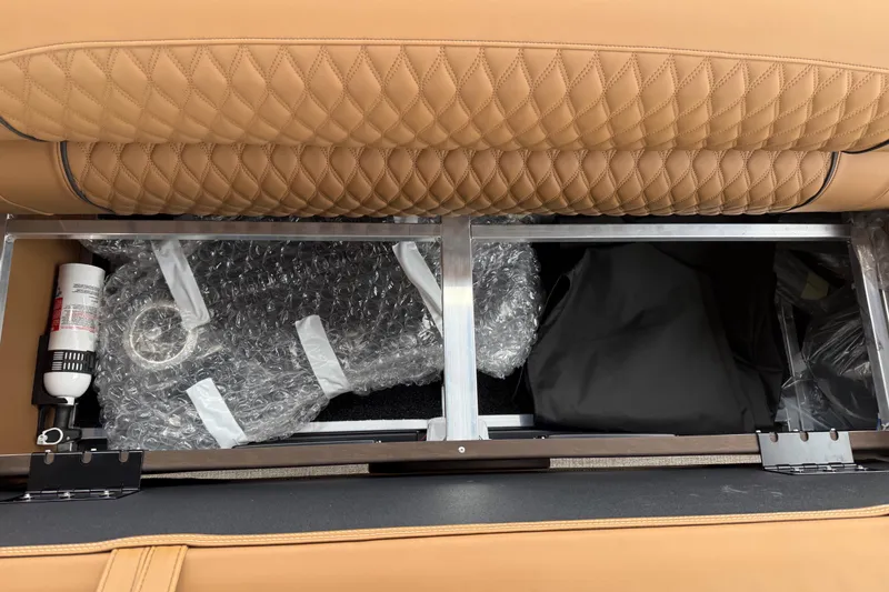 Slide: The Image of Storage compartment in Avalon Catalina Cruise Funship 2026 with quilted leather seating and safety equipment. - 43