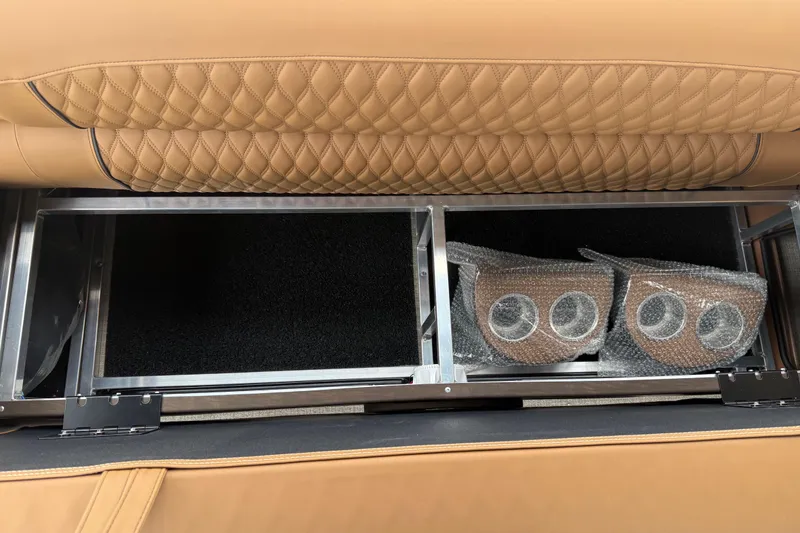 Slide: The Image of 2026 Avalon Catalina Cruise Funship storage compartment with quilted tan upholstery and bubble-wrapped accessories. - 46
