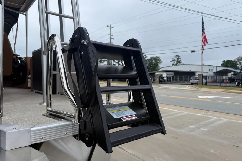 Slide: The Image of Ladder on 2026 Avalon Catalina Cruise Funship pontoon boat, parked near a road. - 6