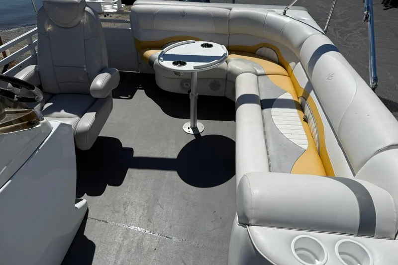 Slide: The Image of 2011 JC NEPTOON SPORT 21TT boat interior with white and yellow seating and a round table. - 11