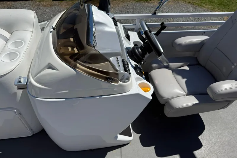 Slide: The Image of 2011 JC NEPTOON SPORT 21TT boat cockpit with steering wheel and comfortable seating. - 12