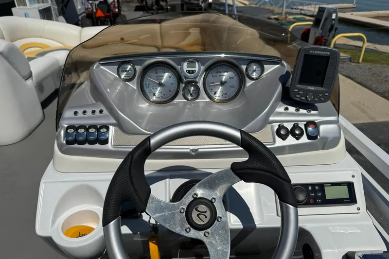 Slide: The Image of Steering console of a 2011 JC NEPTOON SPORT 21TT boat with gauges and controls. - 14