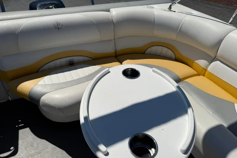 Slide: The Image of 2011 JC NEPTOON SPORT 21TT boat interior with yellow and white seating and round table. - 17