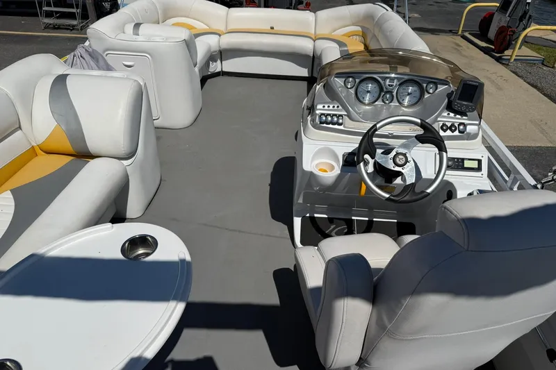 Slide: The Image of 2011 JC NEPTOON SPORT 21TT boat interior with plush seating and modern dashboard. - 19