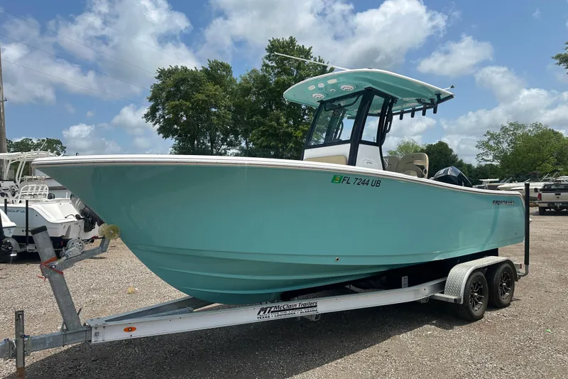 The Image of 2026 Sportsman Open 232 Center Console boat on trailer, parked outdoors. - 0